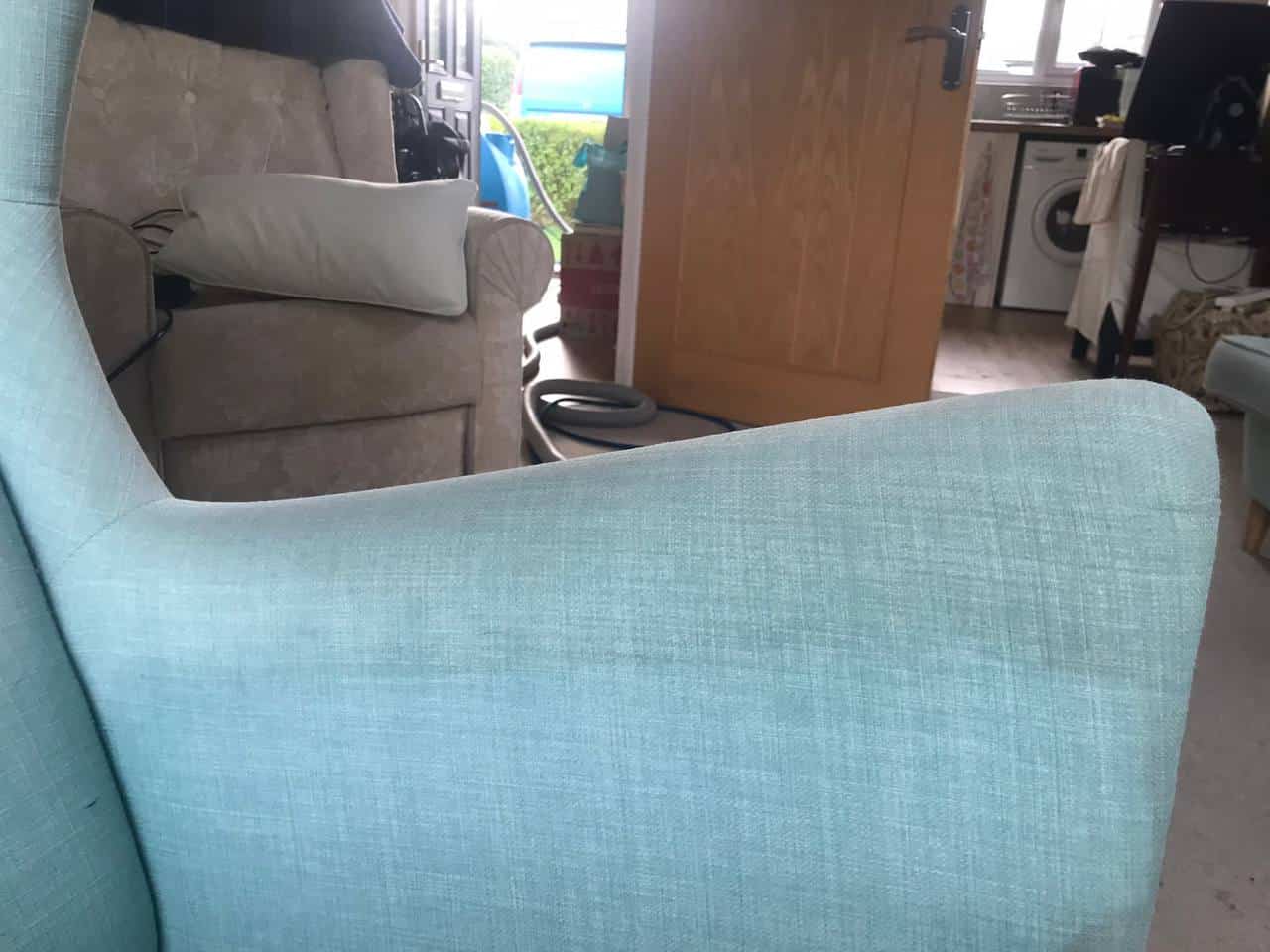 This is the arm of a blue sofa that is just about to be steam cleaned by K&S Carpet Cleaning